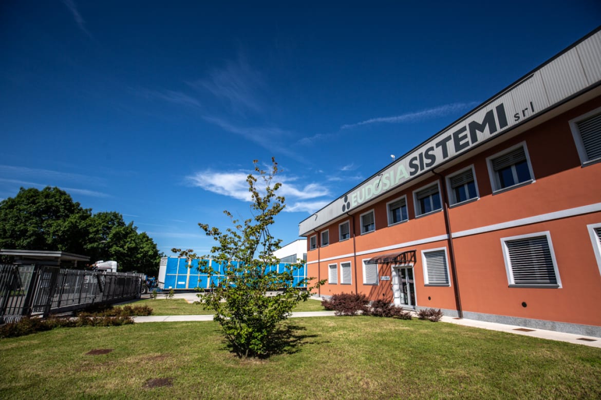 Eudosia Sistemi office building exterior with lawn and sign