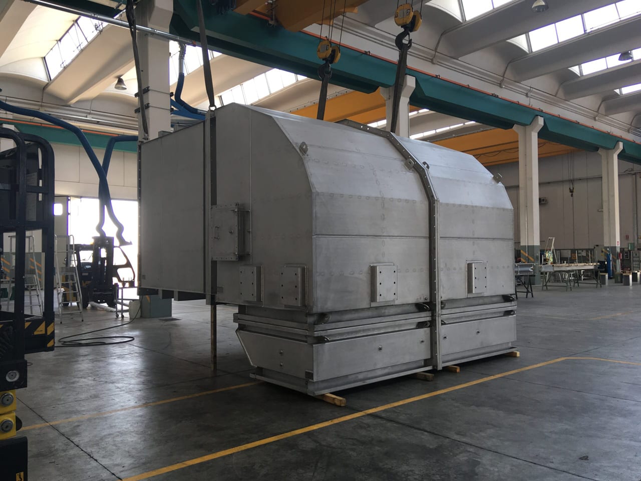 Stainless exhaust silencer section suspended from the overhead crane