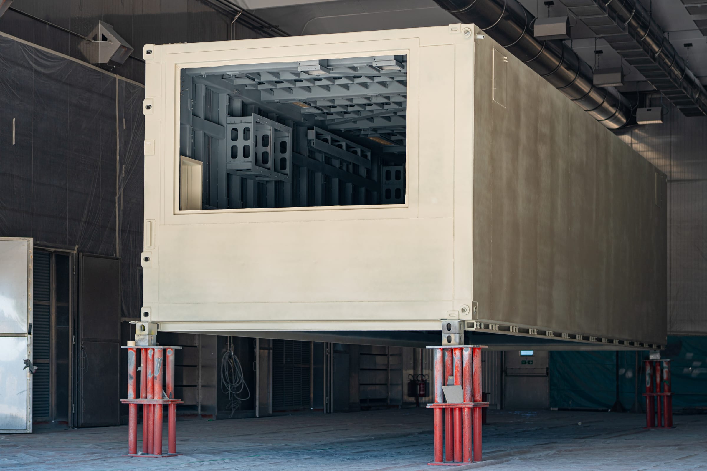 Prefabricated module under construction on jacks inside the Magenta hall