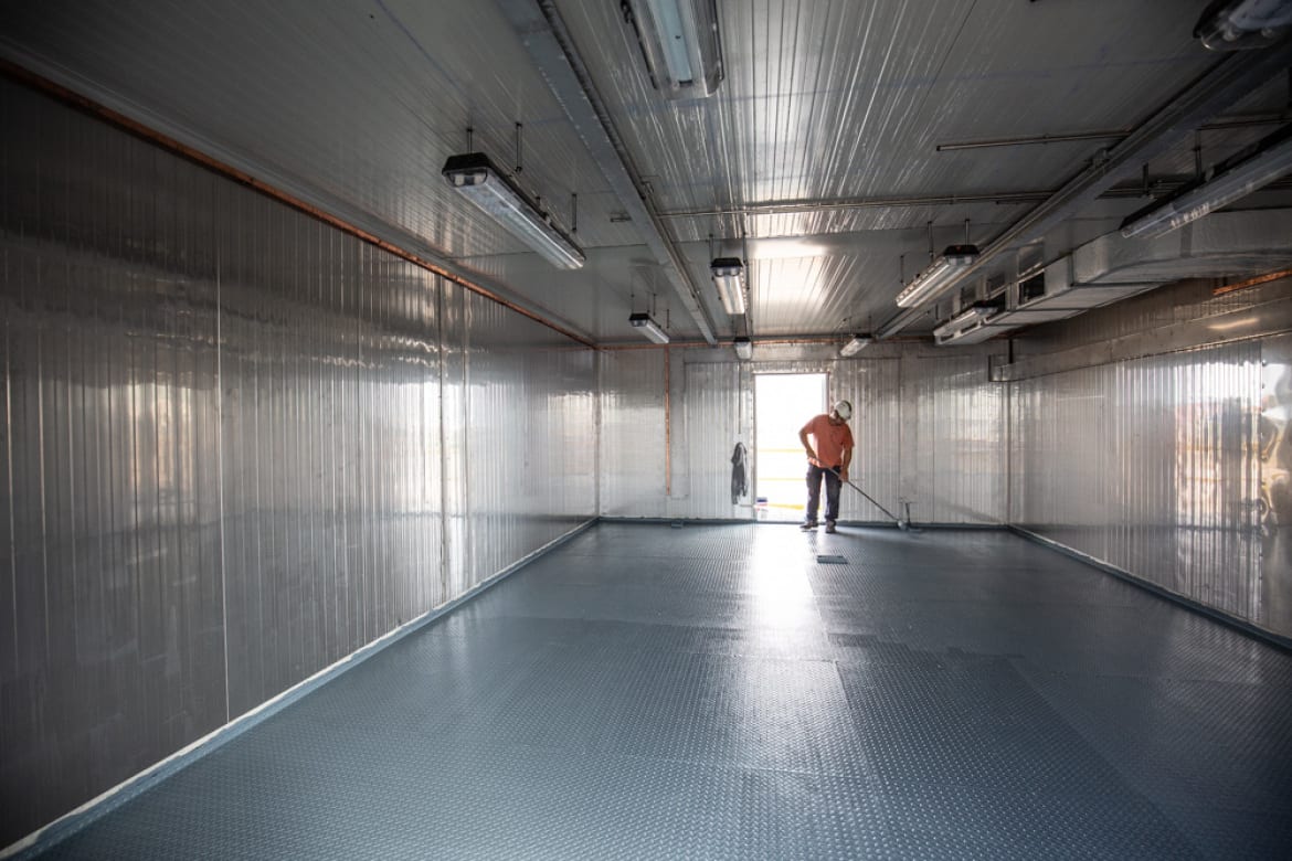 Interior of a finished shelter with panelled walls, lighting and anti-slip floor